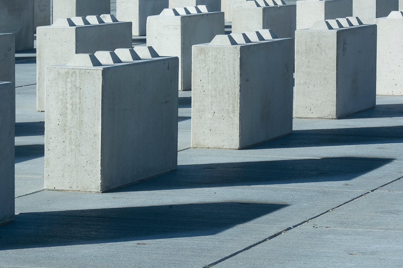 Concrete blocks casting shadows create an abstract, symmetric urban design.